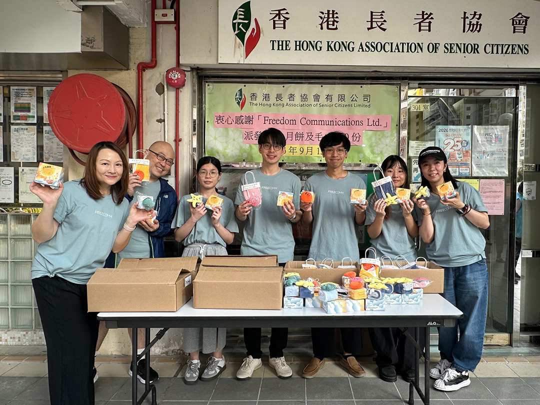 FreeComm volunteer team and elderly residents — group photo